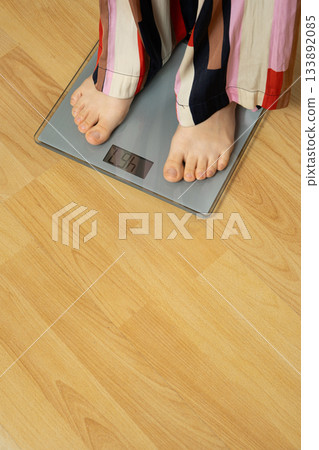 Bare Feet Standing on Modern Digital Bathroom Scales for Weighing. Bare Feet Standing on Modern Digital Bathroom Scales for Weighing. 133892085