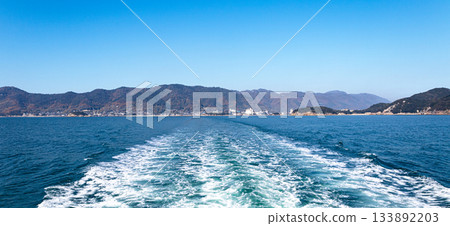 Blue sky and the wake of a ferry sailing across the Seto Inland Sea 133892203
