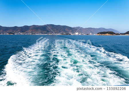 Blue sky and the wake of a ferry sailing across the Seto Inland Sea Blue sky and the wake of a ferry sailing across the Seto Inland Sea 133892206