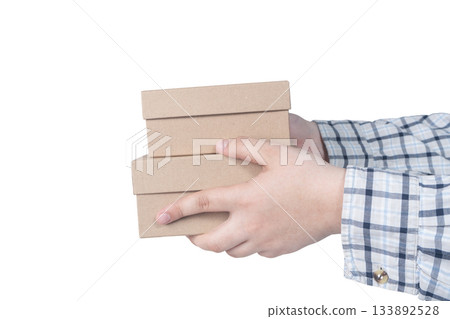 Hands of delivery man holding boxes isolated on white background. High quality photo 133892528