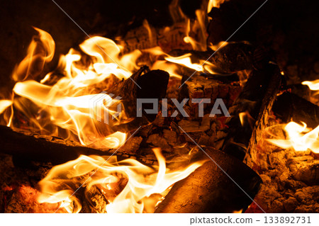 Close-up of Logs Burning with Intense Yellow and Orange Flames. Close-up of Logs Burning with Intense Yellow and Orange Flames. 133892731