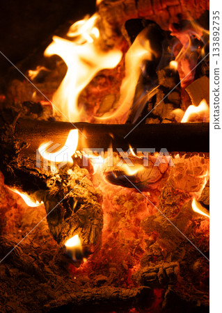 Close-up of Logs Burning with Intense Yellow and Orange Flames. Close-up of Logs Burning with Intense Yellow and Orange Flames. 133892735