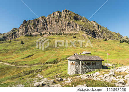 Stone chapel in mountain landscape at Pragelpass summit, Muotathal, Canton of Schwyz, Switzerland Stone chapel in mountain landscape at Pragelpass summit, Muotathal, Canton of Schwyz, Switzerland 133892968