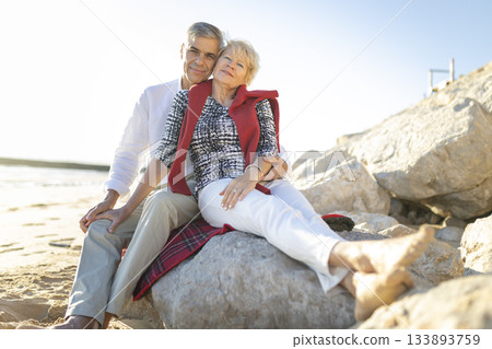 Senior couple embracing on beach enjoying retirement 133893759