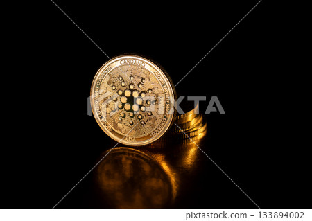 Cardano cryptocurrency coin on black. 133894002