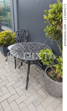 sunlit urban patio with seating, perfect spot for relaxing coffee or reading in tranquil city environment 133894271
