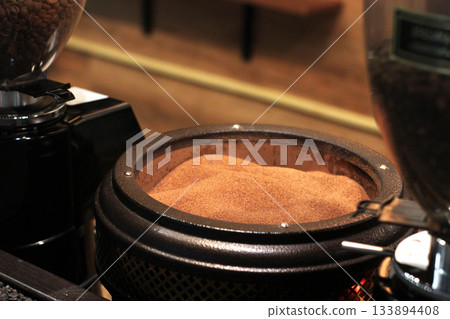 Freshly ground coffee fills a grinder bowl, ready for brewing. The fine, rich brown coffee powder offers an inviting aroma and promises a flavorful cup. Freshly ground coffee fills a grinder bowl, ready for brewing. The fine, rich brown coffee powder offers an inviting aroma and promises a flavorful cup. 133894408