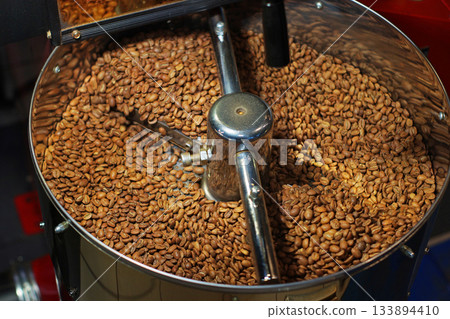 Freshly ground coffee fills a grinder bowl, ready for brewing. The fine, rich brown coffee powder offers an inviting aroma and promises a flavorful cup. Freshly ground coffee fills a grinder bowl, ready for brewing. The fine, rich brown coffee powder offers an inviting aroma and promises a flavorful cup. 133894410