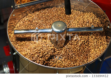 Freshly ground coffee fills a grinder bowl, ready for brewing. The fine, rich brown coffee powder offers an inviting aroma and promises a flavorful cup. Freshly ground coffee fills a grinder bowl, ready for brewing. The fine, rich brown coffee powder offers an inviting aroma and promises a flavorful cup. 133894412