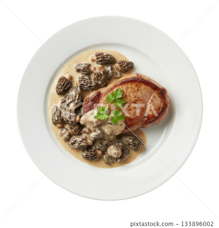Delicious gourmet veal chop dinner with morel mushroom and rich savory cream sauce on white plate from above Delicious gourmet veal chop dinner with morel mushroom and rich savory cream sauce on white plate from above 133896002