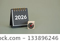 black desk calendar year 2026 with target icon on wooden cubes with copy space, symbolizing goals and planning, business strategy for new year 2026 133896246