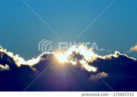 The sun peeking through the clouds in early December 133897233