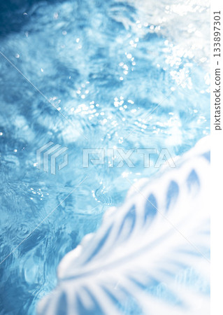 Colorful swim rings and water surface patterns create a summery image 133897301