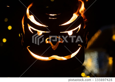 Close-up of a Spooky Metal Fire Basket with an Evil, Glowing Face. Close-up of a Spooky Metal Fire Basket with an Evil, Glowing Face. 133897428