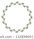 Round wreath frame of green leaves and red berries 133898001