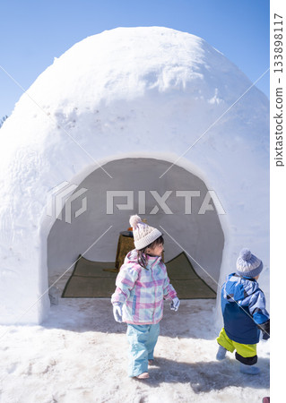 Snow igloos and young children Snow igloos and young children 133898117