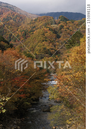 Vibrant autumn foliage colors the Azusa River and mountains in Matsumoto City, Nagano Prefecture Vibrant autumn foliage colors the Azusa River and mountains in Matsumoto City, Nagano Prefecture 133898118