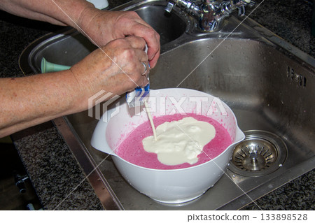 Woman making a quark cake 133898528