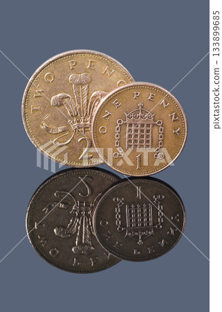 British one penny and two pence on a dark background 133899685