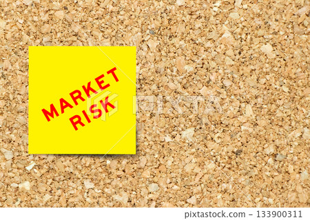 Yellow note paper with word market risk on cork board background with copy space Yellow note paper with word market risk on cork board background with copy space 133900311