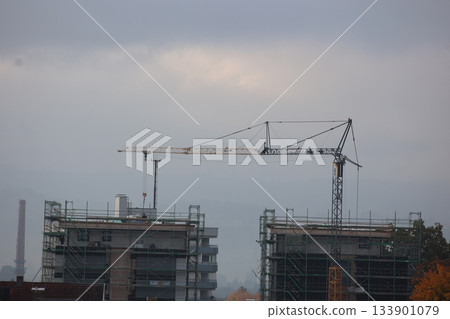 Crane is lifting a building in the distance 133901079