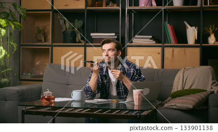 Man recording voice message at home workspace. 133901138