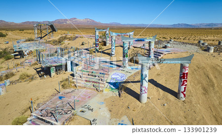 Aerial Abandoned Water Park Graffiti Structures in California Desert 133901239