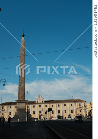 Lateran Obelisk in Piazza San Giovanni in Laterano Rome under blue sky ancient Egyptian granite monument with Latin base inscriptions city square landmark travel Italy. High quality photo 133901462