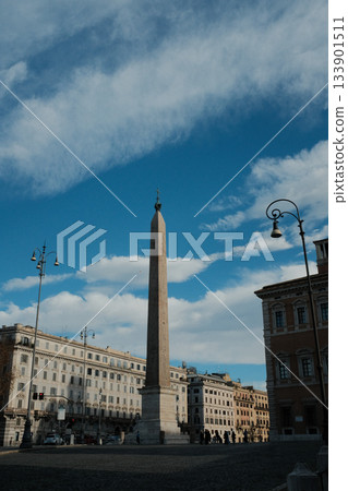 Lateran Obelisk in Piazza San Giovanni in Laterano Rome under blue sky ancient Egyptian granite monument with Latin base inscriptions city square landmark travel Italy. High quality photo 133901511