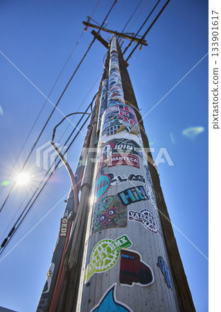 Telephone Pole With Stickers Sunburst And Blue Sky In California 133901617