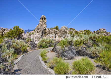 Tufa Formations and Walking Path with Native Brush Under Blue Sky Tufa Formations and Walking Path with Native Brush Under Blue Sky 133901620