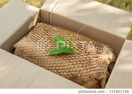 Green leaf on eco friendly brown paper honeycomb wrap for product packaging parcel carton box 133901788