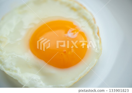 Fried egg on white dish close up 133901823