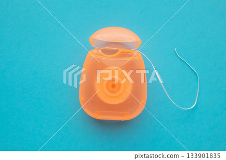 dental floss in case on blue background dental floss in case on blue background 133901835