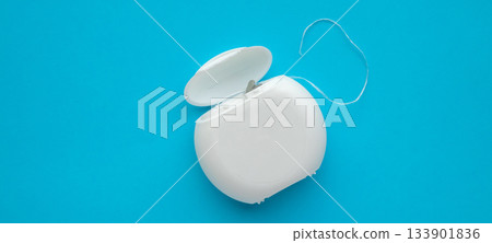 dental floss in case on blue background dental floss in case on blue background 133901836