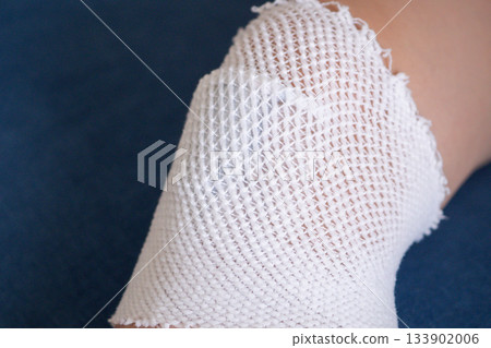 wound dressing bandage on child knee after fall on the ground 133902006
