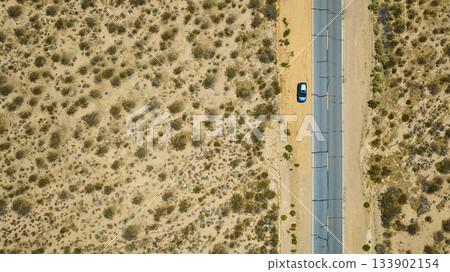 Aerial Mojave Desert Highway Blue Car and California Landscape Top Down Aerial Mojave Desert Highway Blue Car and California Landscape Top Down 133902154