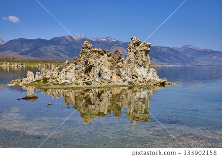 Tufa Towers Reflected in Mono Lake with Sierra Nevada Mountains Under Bright Blue Sky Tufa Towers Reflected in Mono Lake with Sierra Nevada Mountains Under Bright Blue Sky 133902158