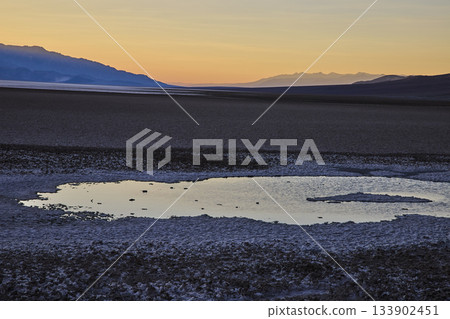 Saltwater Pool and Salt Flats at Golden Hour in Death Valley Desert Landscape 133902451