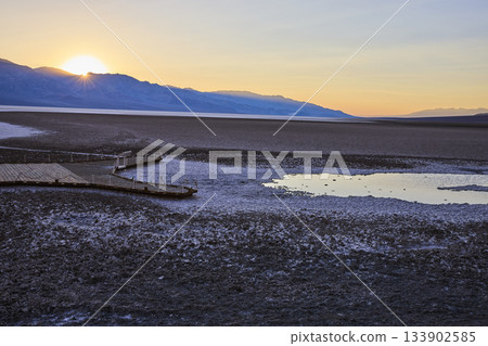 Badwater Basin Salt Flats Boardwalk and Water Pool at Sunset in Death Valley 133902585
