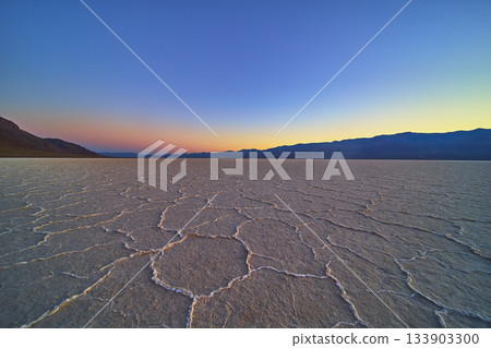 Salt Flats Pattern at Sunrise with Mountains and Golden Hour Sky Salt Flats Pattern at Sunrise with Mountains and Golden Hour Sky 133903300