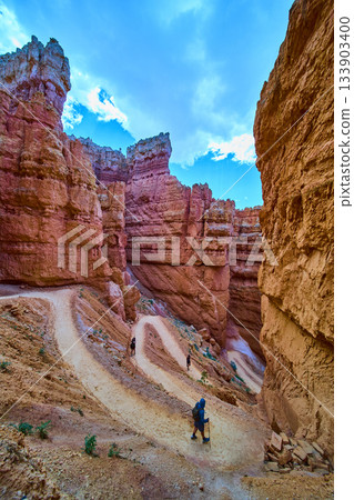 Bryce Canyon Wall Street Switchback Trail With Hikers And Dramatic Red Rock Formations Bryce Canyon Wall Street Switchback Trail With Hikers And Dramatic Red Rock Formations 133903400