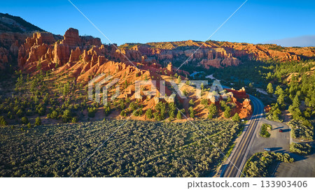 Aerial Red Canyon Hoodoos Pine Trees and Winding Road in Utah Aerial Red Canyon Hoodoos Pine Trees and Winding Road in Utah 133903406