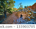 Rock Hut on Arches Trail with Red Rocks and Pine Trees in Sunlit Utah Canyon 133903705
