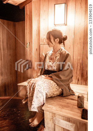 A woman entering a foot bath A woman entering a foot bath 133904019
