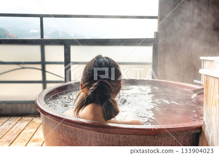 A woman entering a hot spring 133904023