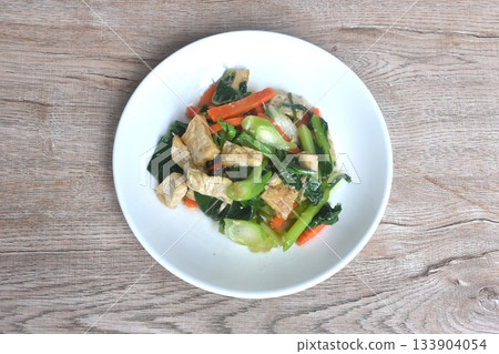 fried Kailaan Chinese kale and carrot with tofu dressing soy sauce vegetarian food on plate fried Kailaan Chinese kale and carrot with tofu dressing soy sauce vegetarian food on plate 133904054