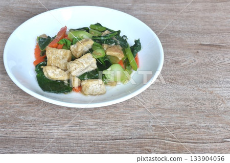 fried Kailaan Chinese kale and carrot with tofu dressing soy sauce vegetarian food on plate 133904056