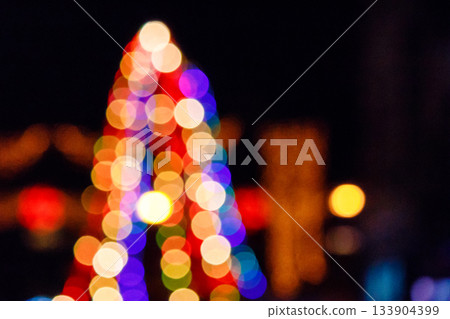 outdoor scene defocused christmas tree. festive abstract background of street for new year with bokeh effect. colorful backdrop with shimmering garlands for winter holidays outdoor scene defocused christmas tree. festive abstract background of street for new year with bokeh effect. colorful backdrop with shimmering garlands for winter holidays 133904399