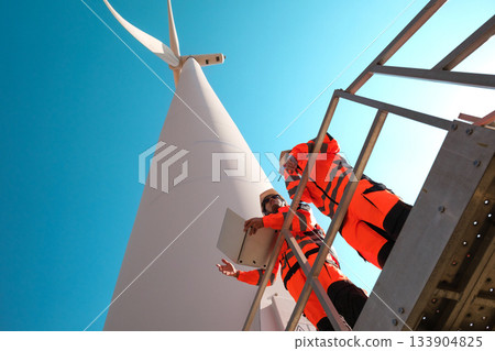 Engineers are inspecting wind turbines to generate electricity. 133904825